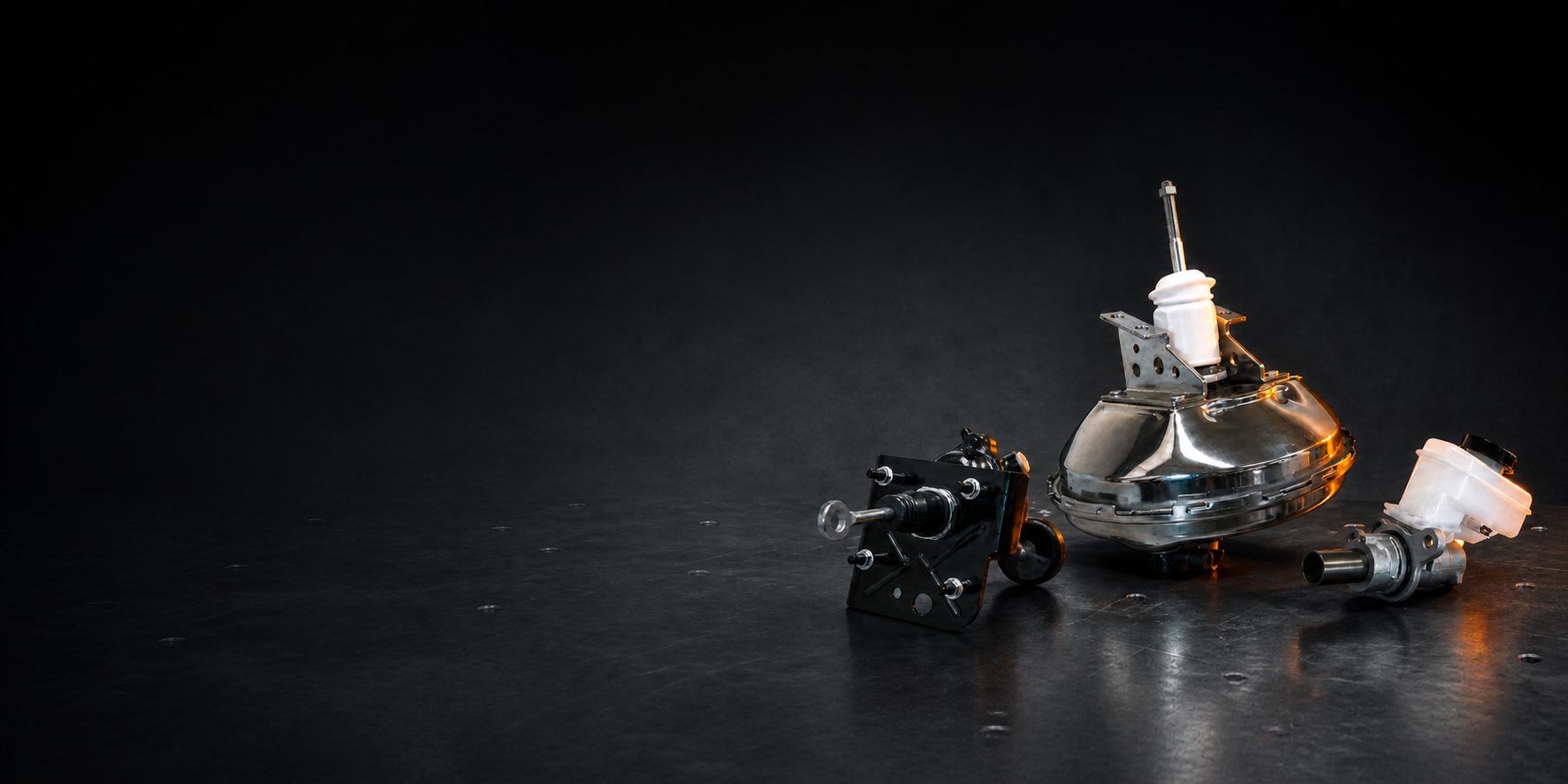 Three complete AOYIDA brake-actuation products in a dark engineering studio